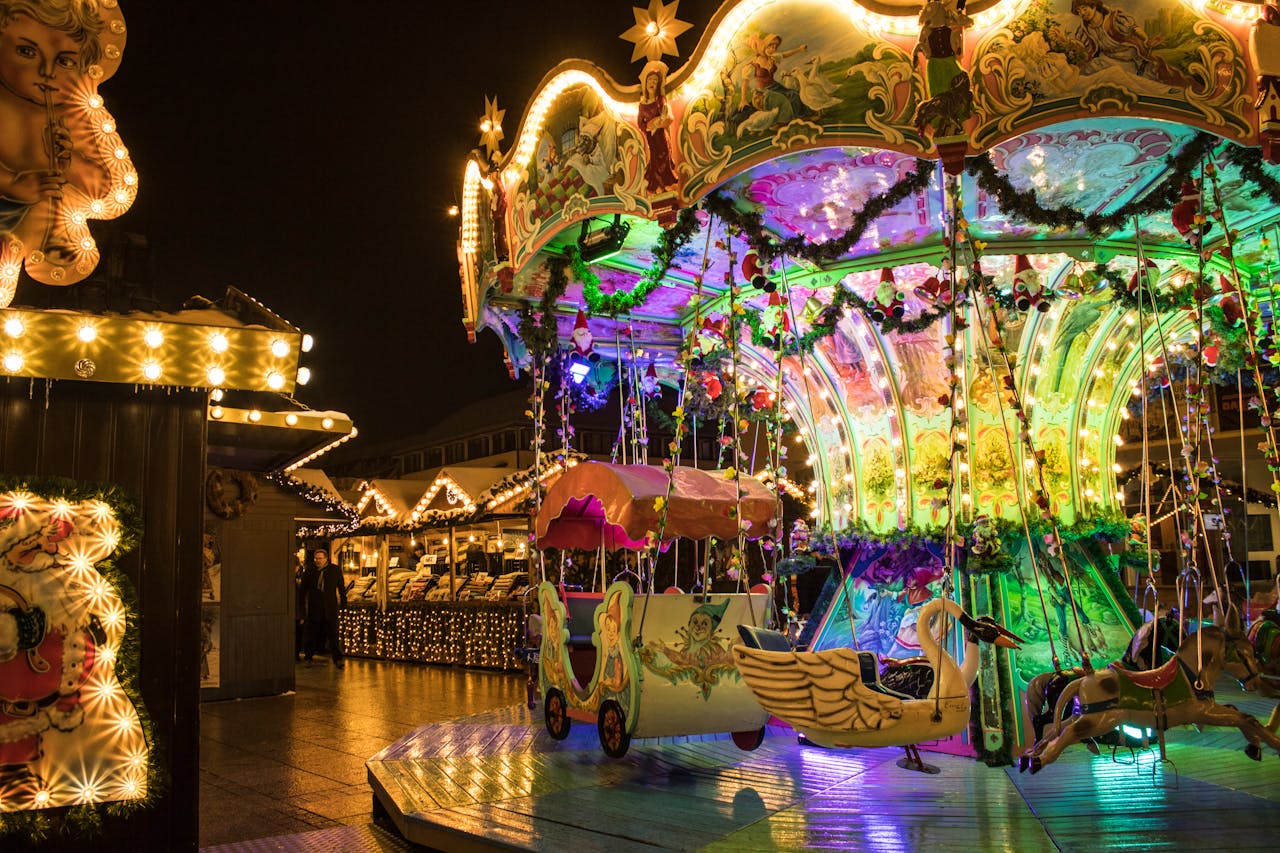 Vibrantly illuminated carousel at night in Ulm, Germanys festive fairground.
