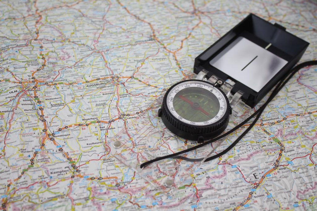 Close-up of a compass on a detailed map of Germany, ideal for travel and navigation themes.